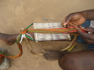 Threading the Heddles for Kente Weaving