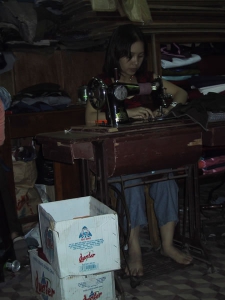 Woman Sewing in Vietnam Tailor Shop