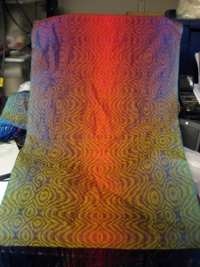 View of the Ocean Sunset II shawl before wet-finishing