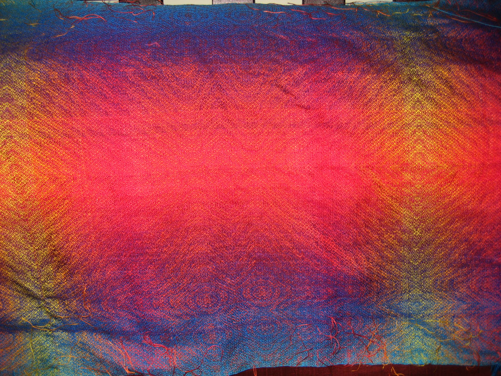 A closer view of the unfinished shawl, showing the color transitions.