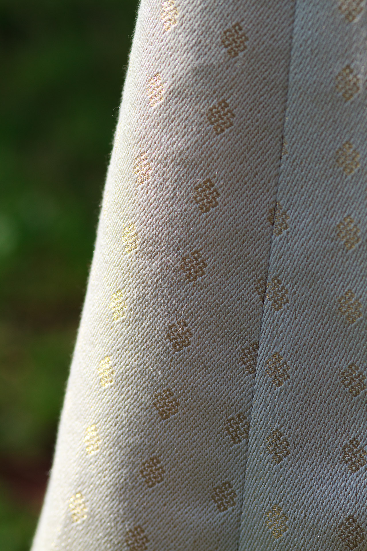 Closeup of pattern in handwoven wedding dress