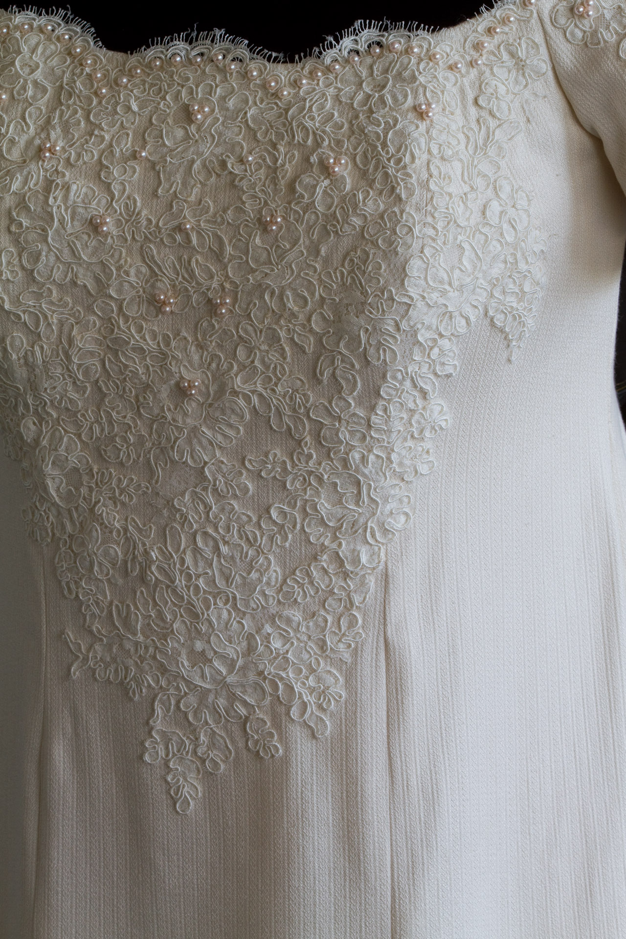 closeup of handwoven wedding dress, on dress form