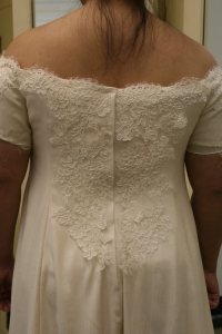 Partially completed handwoven wedding dress, with the back lace basted on.