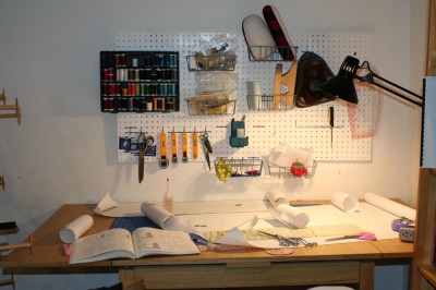 My sewing table, spread out with my first project, with the pegboard organizer in the background.