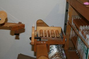 Tension box mounted on the back of the loom.
