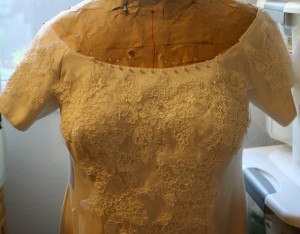 Lace and pearls on dress, close up
