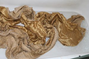 Coat fabric being wet-finished in bathtub