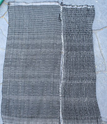 Plain weave and waffle weave, networked and allover pattern, with white overtwisted wool weft, beaten loosely.  Warp is black 60/2 silk sett at 40 epi.