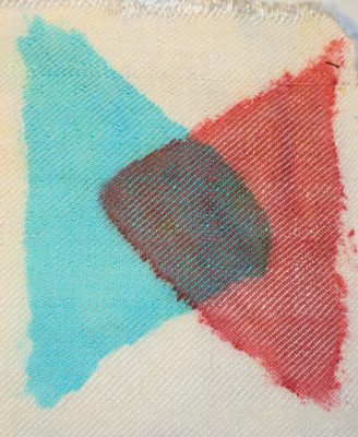 triangle in turquoise fiber-reactive dye, overlapped by triangle in red acid dye