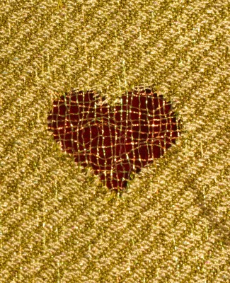 Devore hearts, metallic nylon against a red velvet background