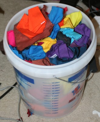 a five gallon bucket filled with dyed swatches!