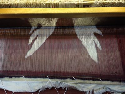 stenciled warp, before being woven