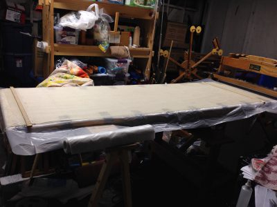 five feet of warp woven with sacrificial weft and then stretched out on the table