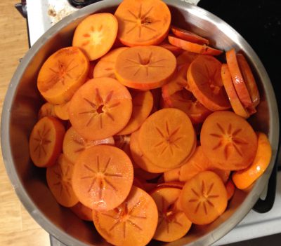 several pounds of persimmons, cut up for drying