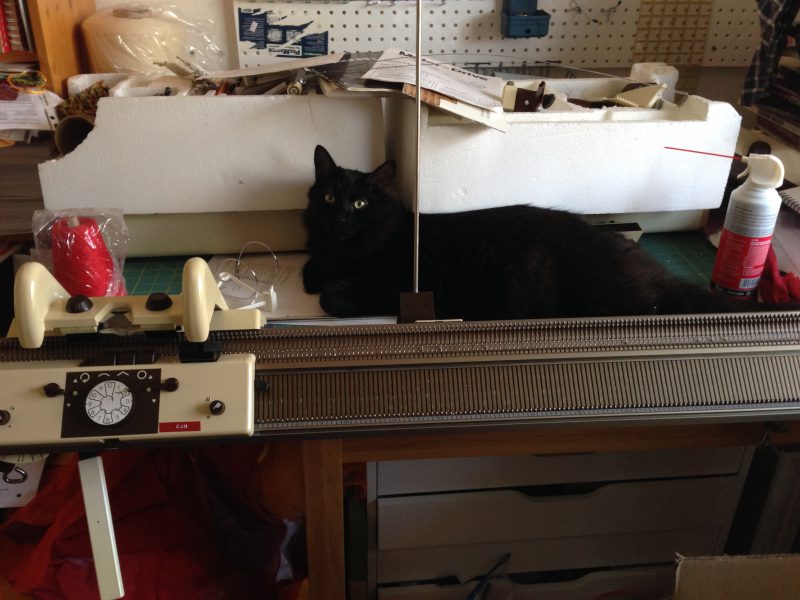 Fritz supervising work on the knitting machine