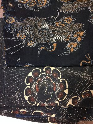 Two pigment-dyed fabrics. The bottom one is nearly new and shows harsh coloring using rust pigments. The top has been washed multiple times, washing away the dark rust areas and leaving a much softer, more appealing look.