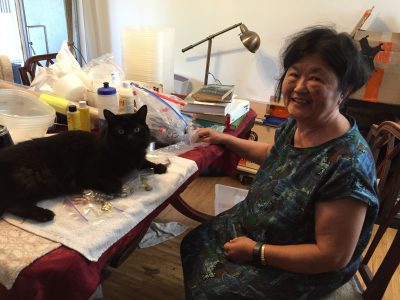Fritz helping my mom with her beading