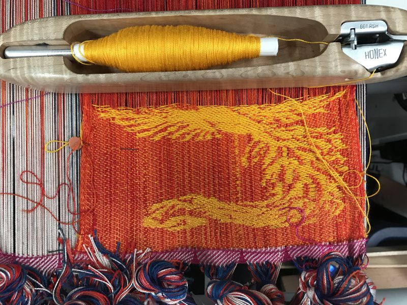Red warp, golden yellow weft for handwoven phoenix and dragon scarf