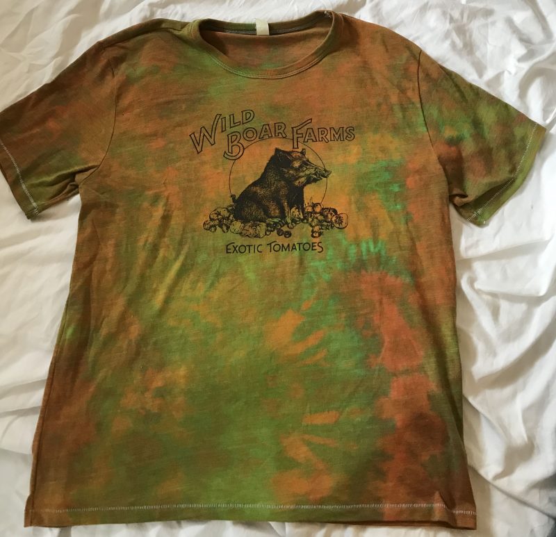 A Wild Boar Farms T-shirt tie-dyed in orange and green