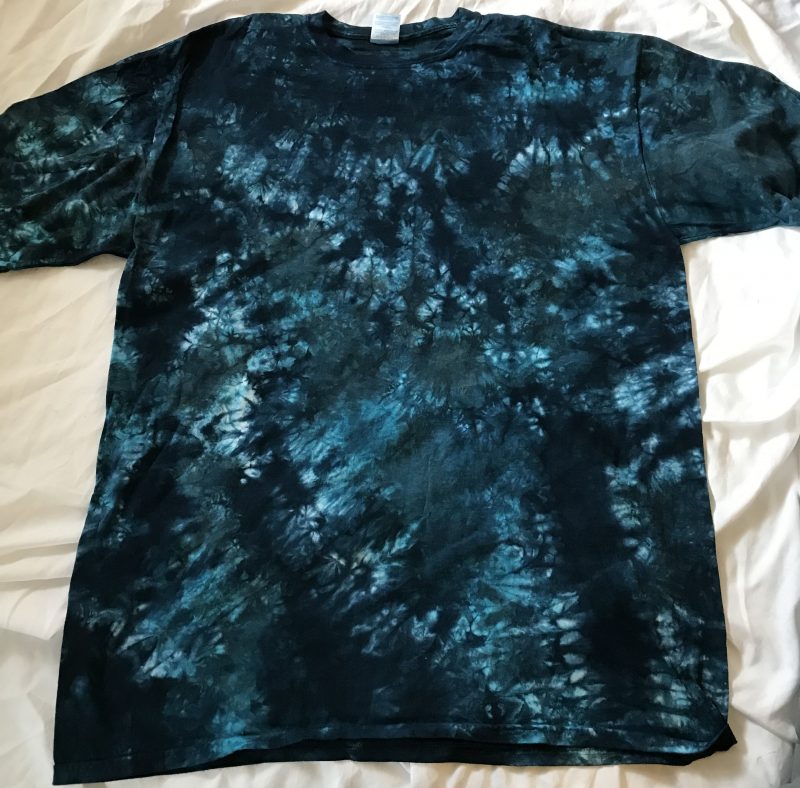 A T-shirt tie-dyed in indigo blue and steel gray