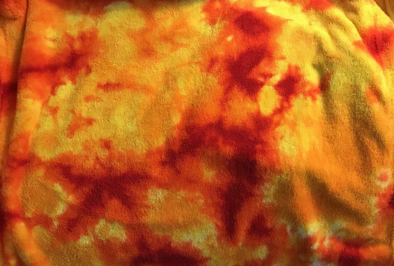 closeup of flame-dyed bathrobe, showing the intense patches of red centered in the patches of orange