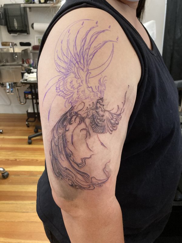 After half an hour of tattooing - the bottom half of the phoenix outlined.