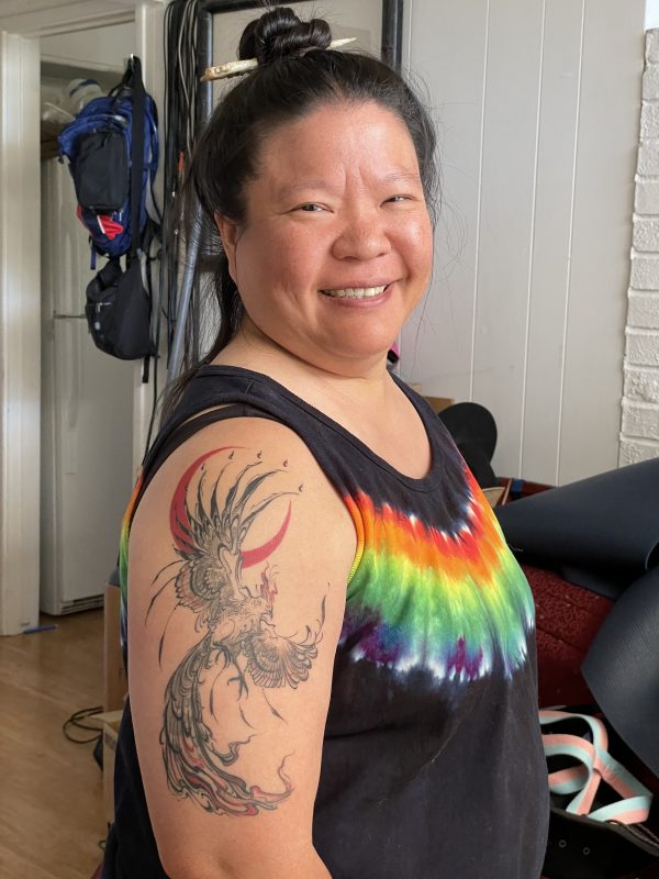 Tien with a phoenix tattoo